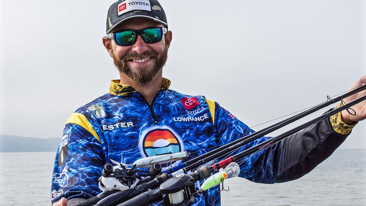 brandon lester holding several bass fishing lures he uses during the fall