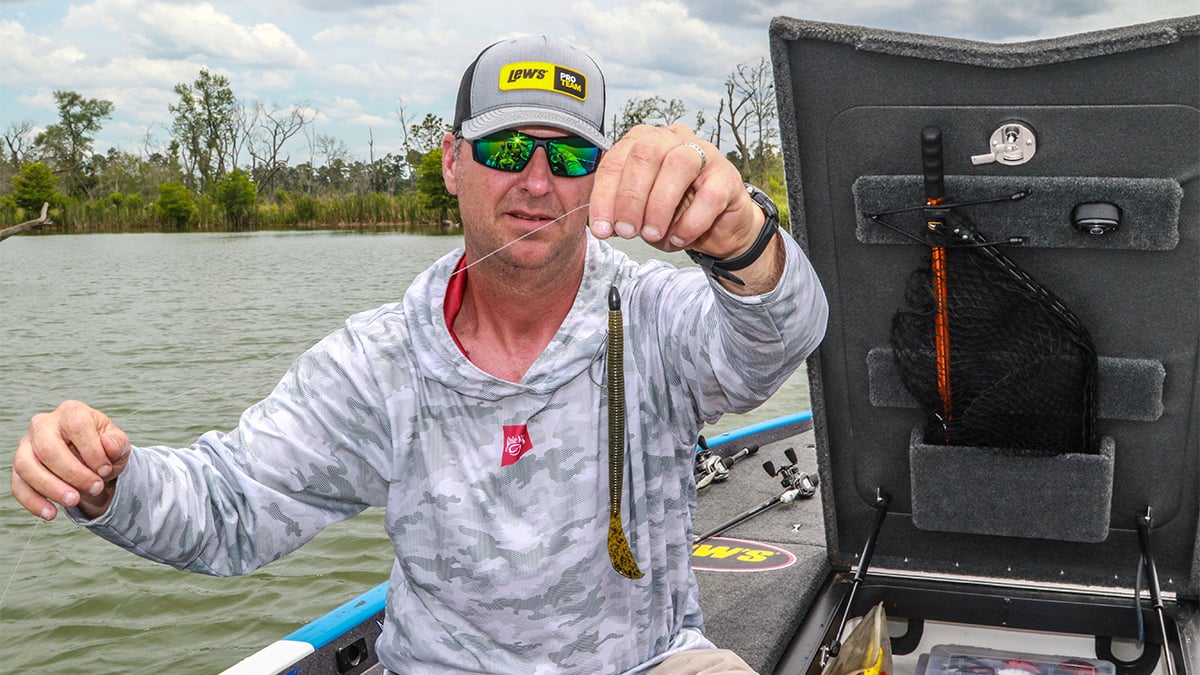 fisherman holding bass fishing worm