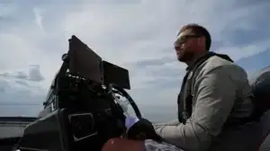 Bass angler driving a bass boat with electronics