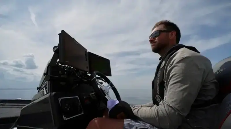 Bass angler driving a bass boat with electronics