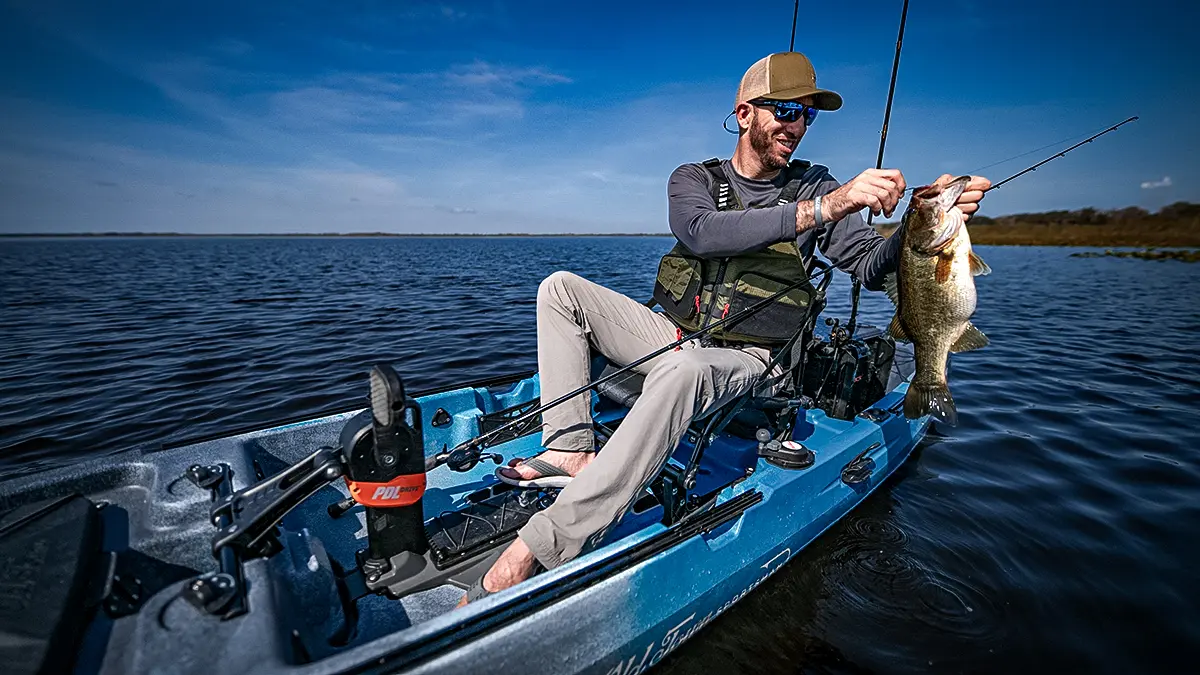 Old Town Fishing Kayak with man pulling bass from water
