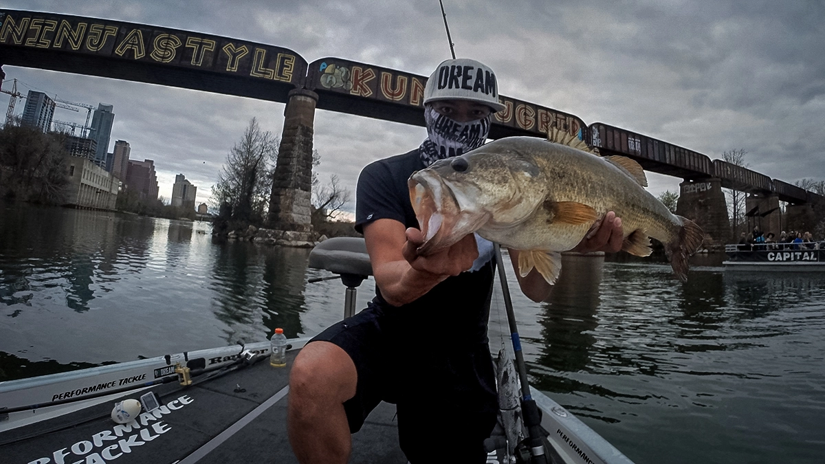 oliver ngy with a largemouth near a train bridge