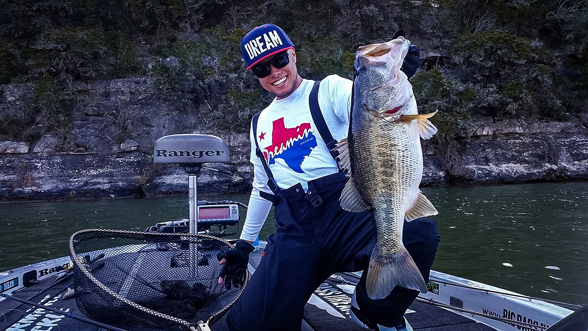 oliver ngy in a boat with a nice bass