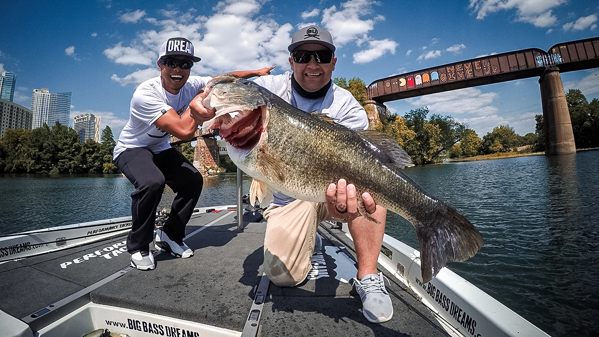 oliver ngy and friend with a nice bass by a train bridge