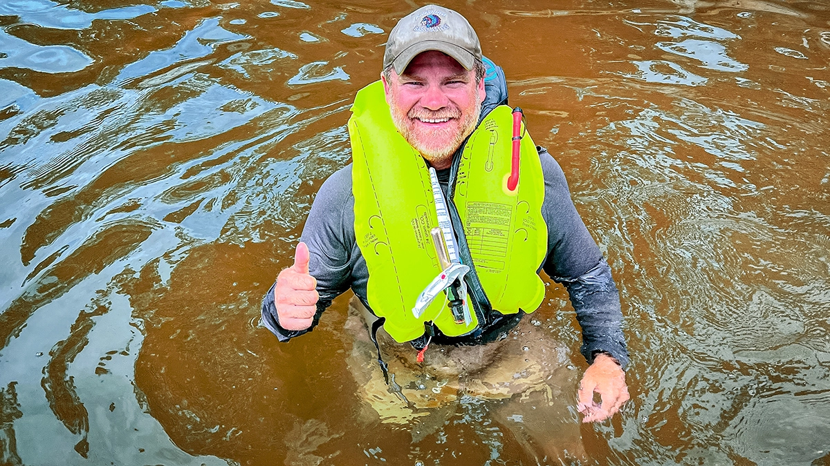 man in water with in inflated PFD