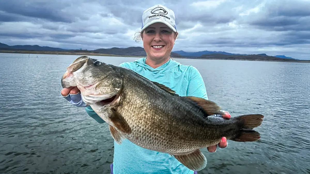 a woman with a large bass on el salto