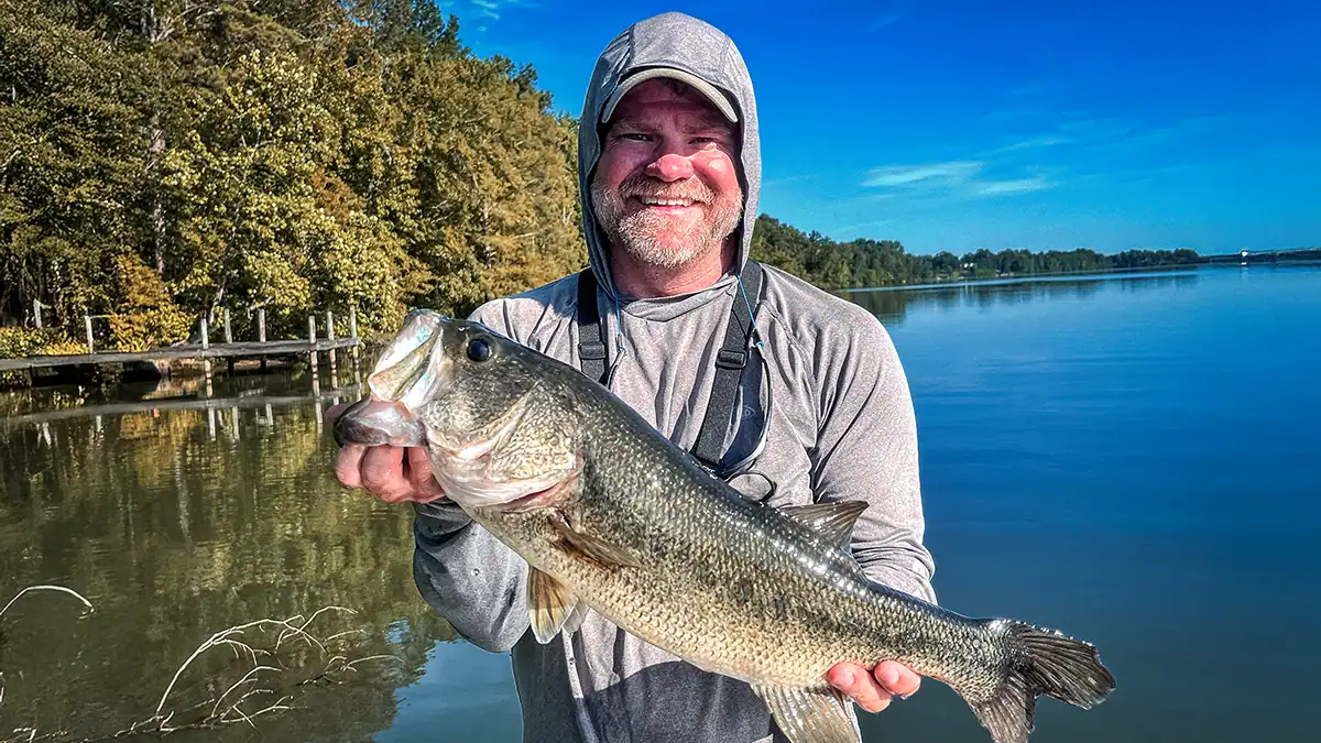 an angler holding a large bass