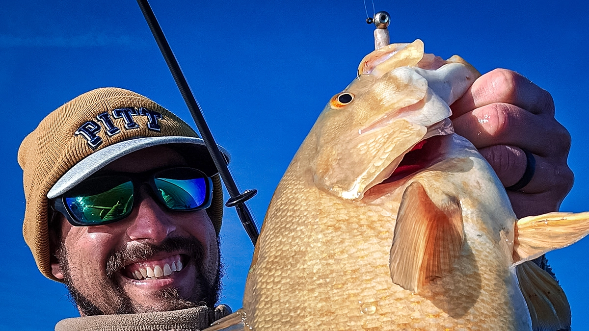 bass on a lure smiling angler