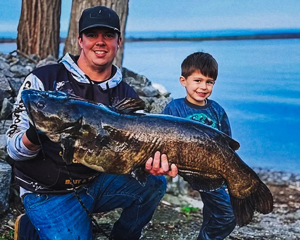 Dylan Kampnich and his son Kaden with Dylan's huge channel catfish. It beat the previous New York state record by nearly 2 pounds.