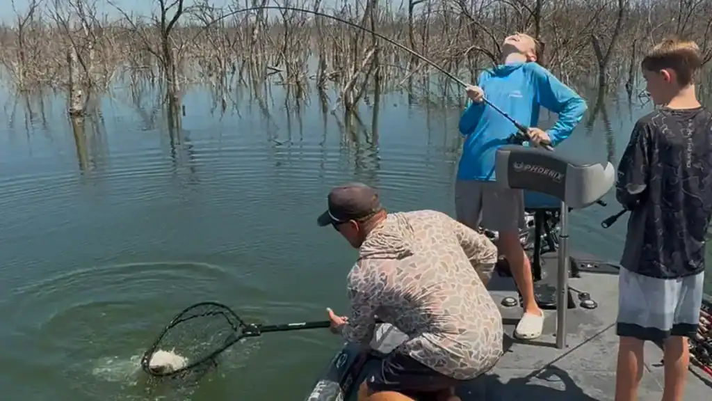Jason Conn netting youth record bass by Wilson