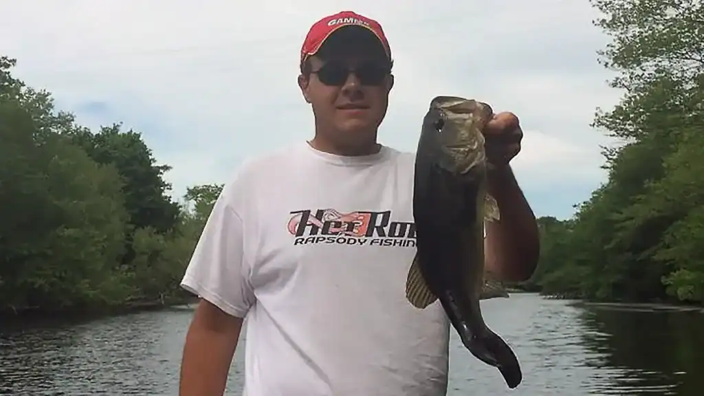 young Nick Petrou with big pond bass
