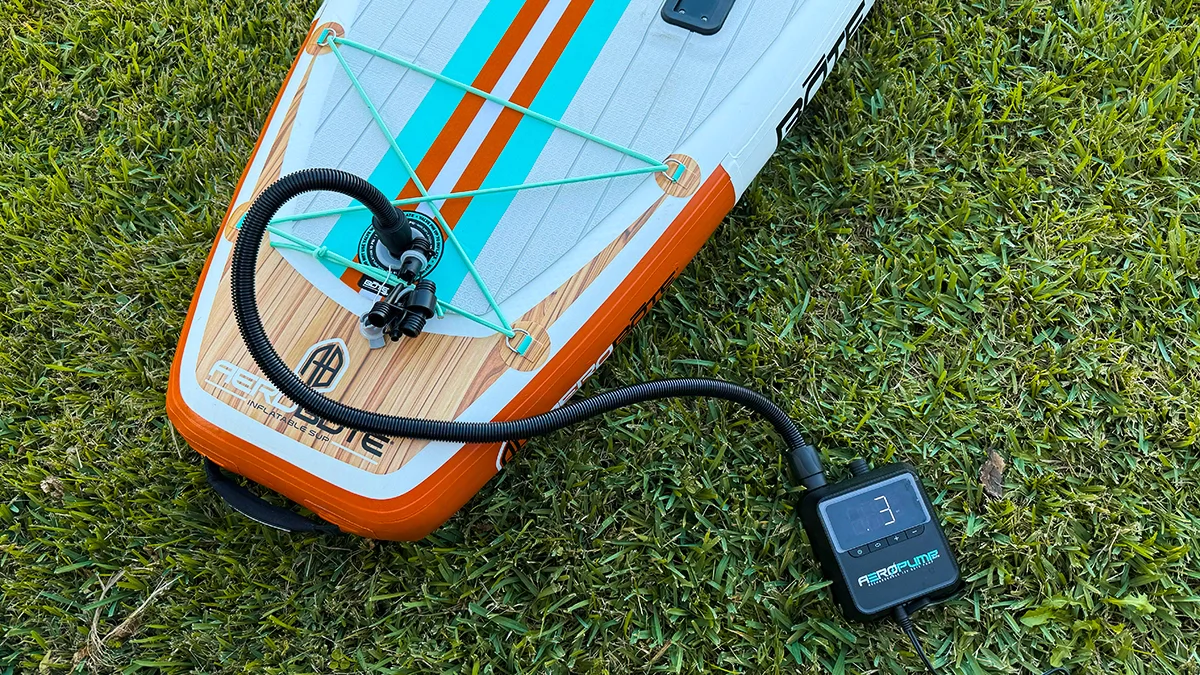 A shot above the BOTE HD Aero SUP, which has been placed on grass and attached to a pump