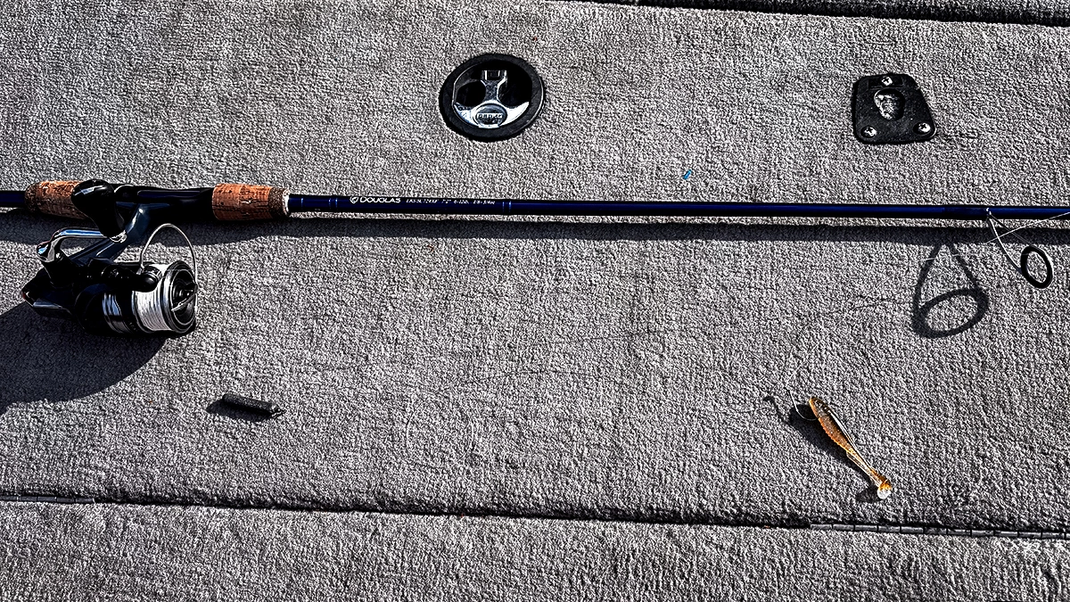 A fishing rod laid out with a dropshot bait