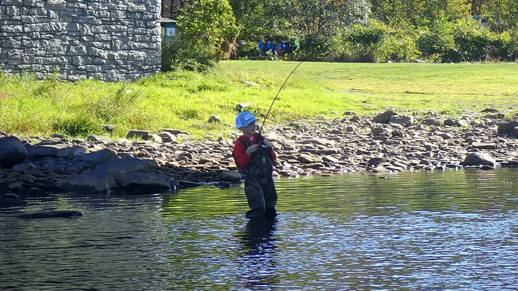 child wading in river