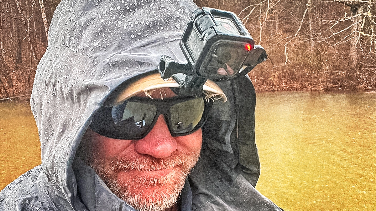 A man wears the Leupold Performance Eyewear Switchback Daylight Max Sunglasses with rain gear