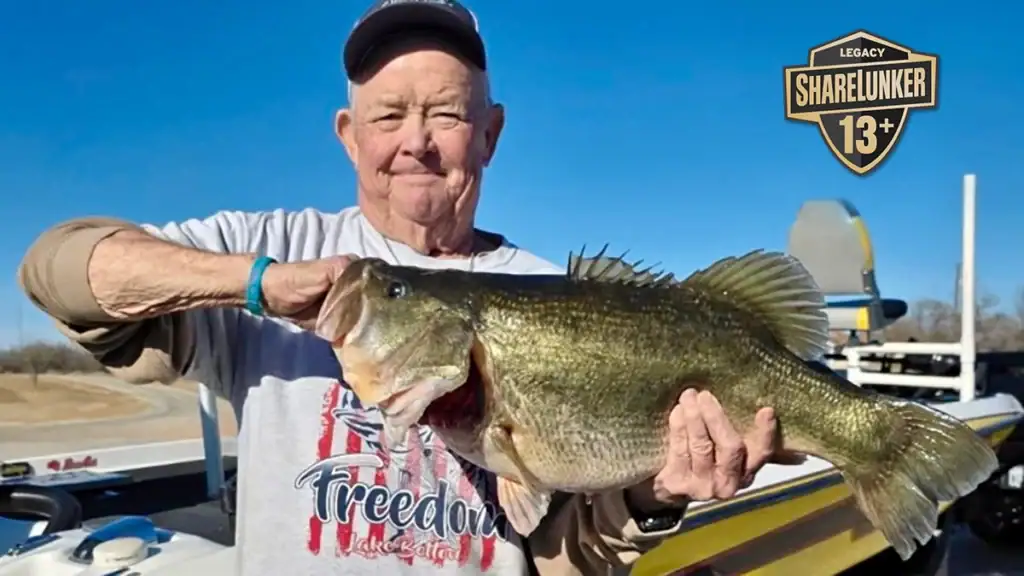 Holding a Texas largemouth bass weighing 14.35 pounds