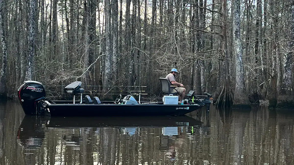 Already wearing short pants. A crappie angler fishes the shallows of the Tchefuncte River in early late February.