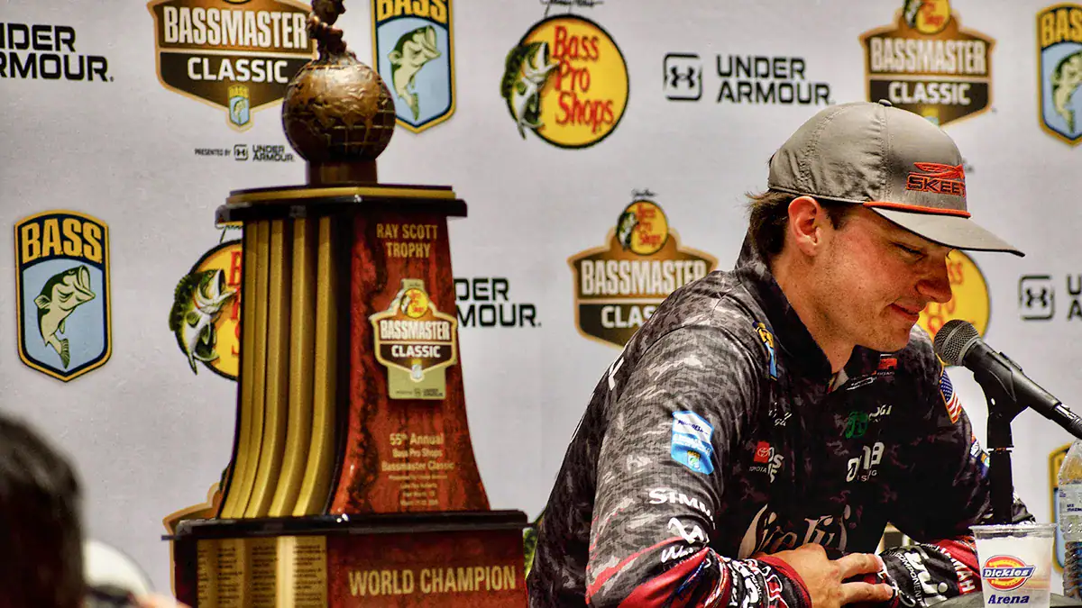 Easton Fothergill is interviewed next to the Ray Scott Trophy after winning 2025's Bassmaster Classic.