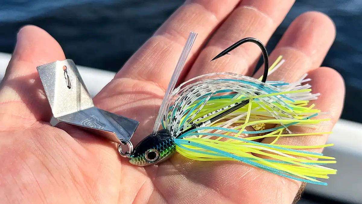 An open hand holding the Teckel USA Bladewaker Bladed Jig 1/2oz bait.