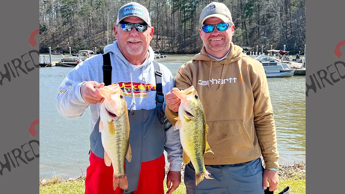 Two men show off the bass they caught during the pre-spawn.