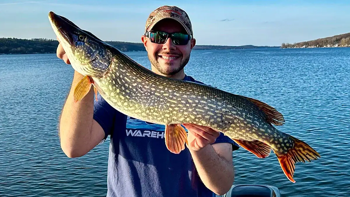 Holding up an early-season Northern Pike on the water.