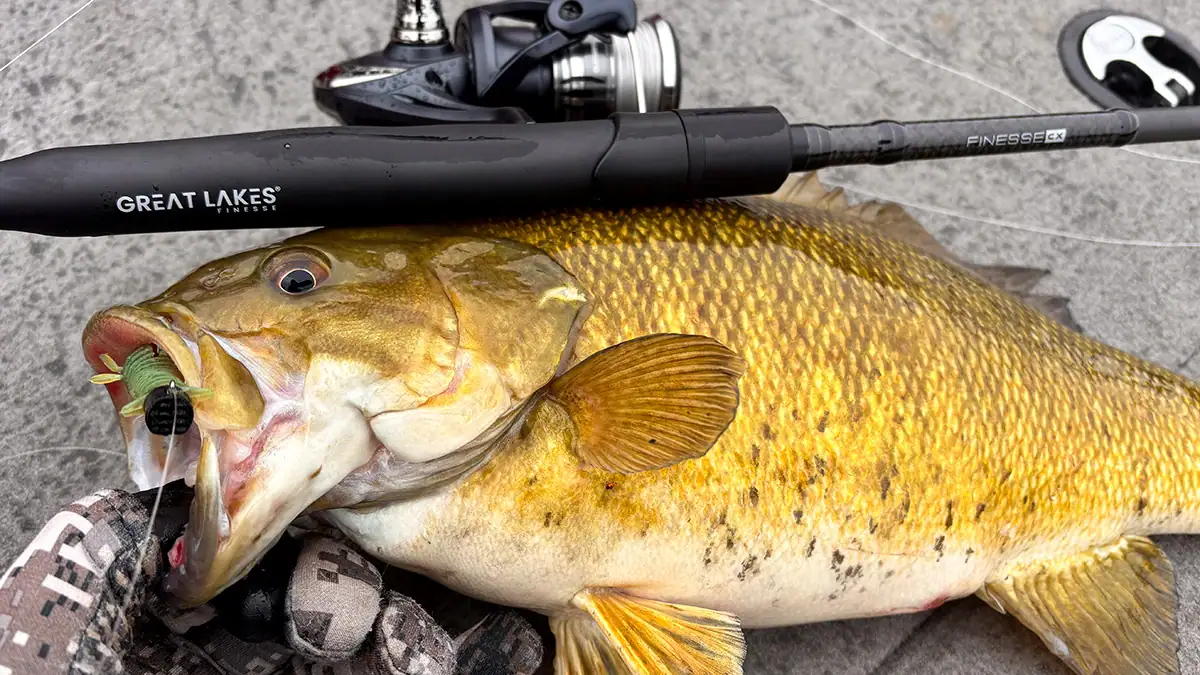 A bass caught during the ice-out period, along with the rod, reel, and bait that caught it.