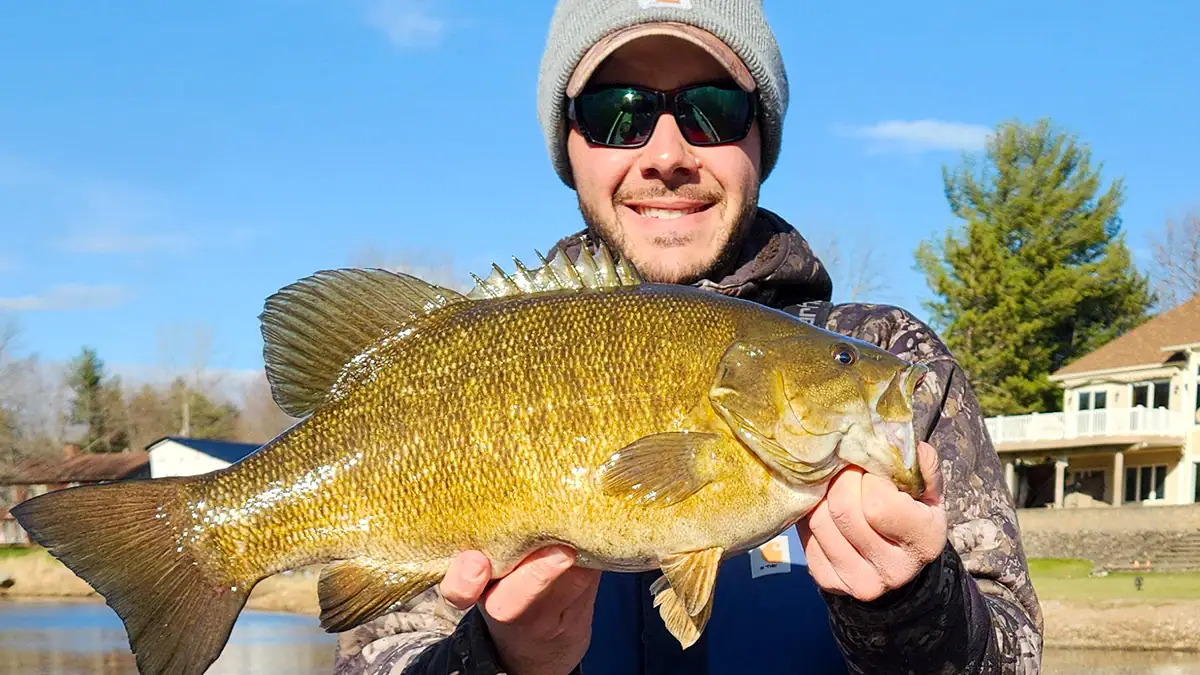 Showing off a bass caught during the ice-out period.