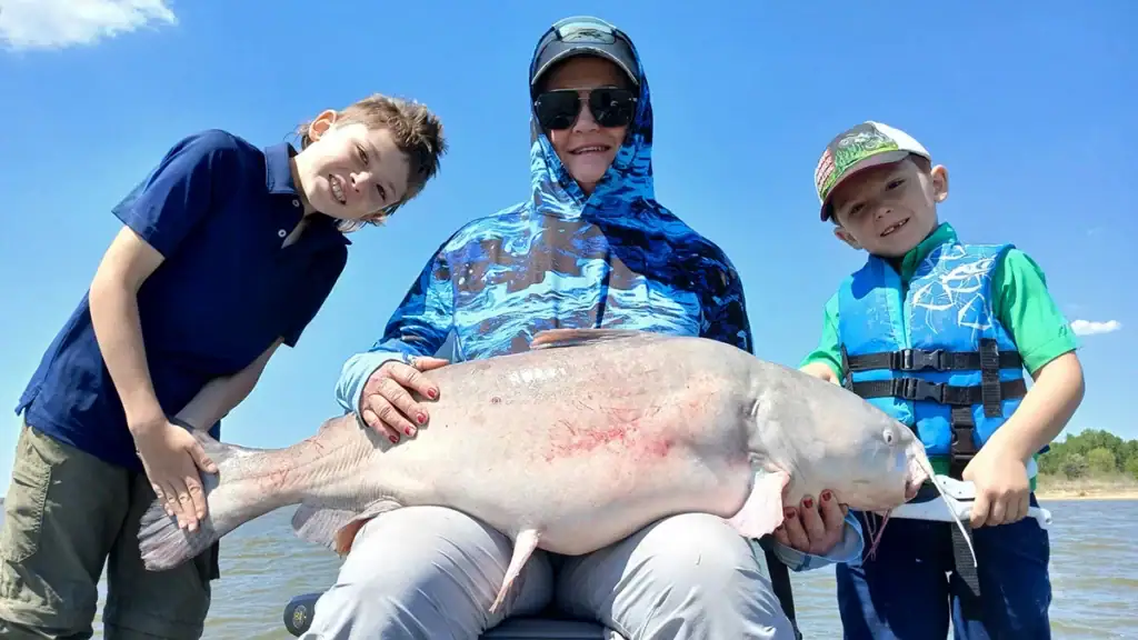 Sally Rhea Thomason sits with the giant catfish that her grandsons Ford and Sam Zinn recently caught.