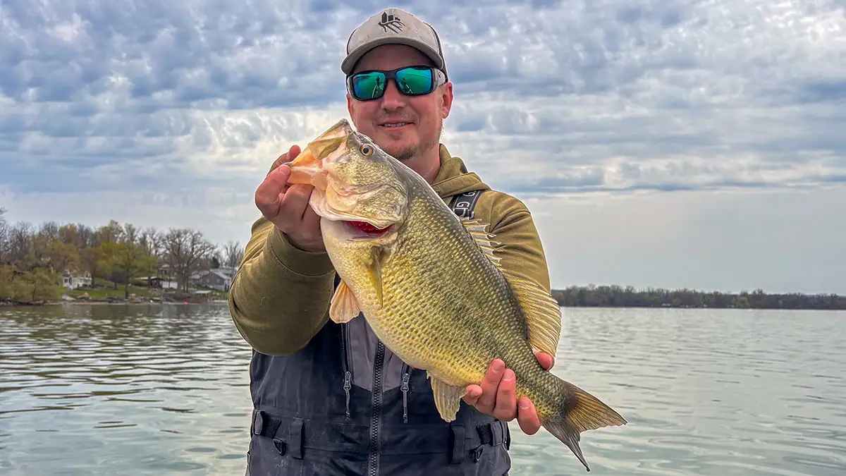 An angler shows off the bass he caught with a skirted jig.