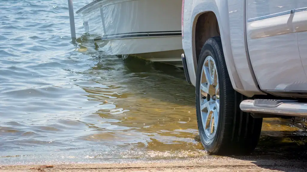 Truck backing down a boat at a ramp