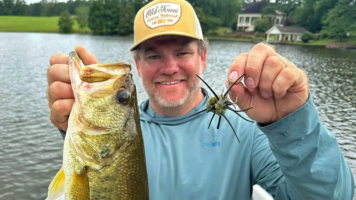 The author shows off his DIY urchin bait and the bass it caught.