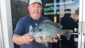 Tom Farchione posed with the world-record redear sunfish he caught at Lake Havasu in Arizona.