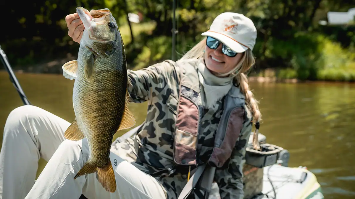 Pro kayak angler Kristene Fisher with her July 6 catch she believes is a meanmouth bass.