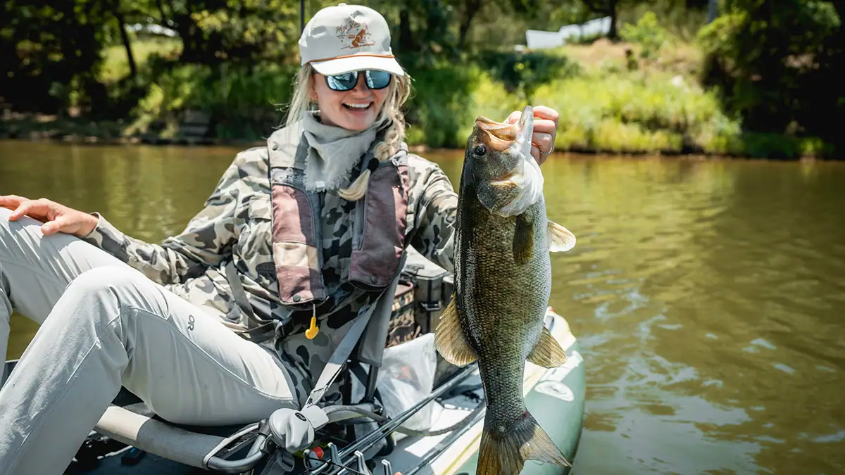 Pro kayak angler Kristene Fisher assesses what she's certain is a meanmouth bass, which she caught July 6 in Texas' Brazos River.