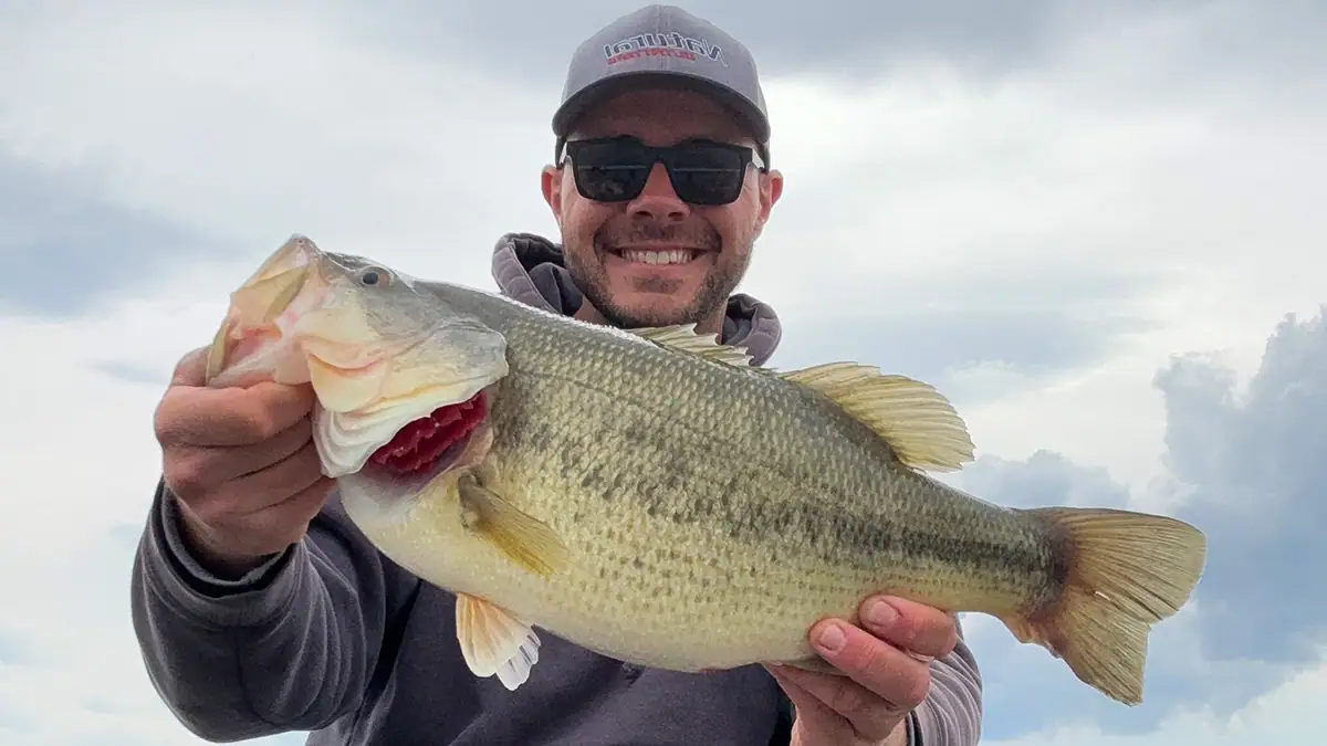 A man holds up a fish caught with a standoff rig.