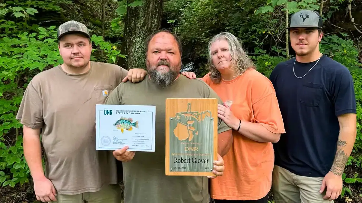 Robert Glover with his wife Franki, sons Sean (left) and Hoyt, and his two newest fishing recognitions.