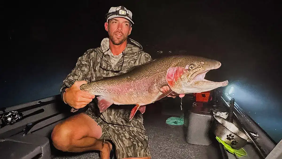 Fishing guide Jesse Brison shows off the nearly 18-pound rainbow trout he caught on July 29.