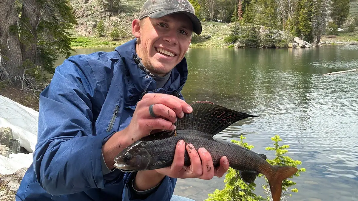Wade Jensen and his state-record Arctic grayling, which he released back into the water.