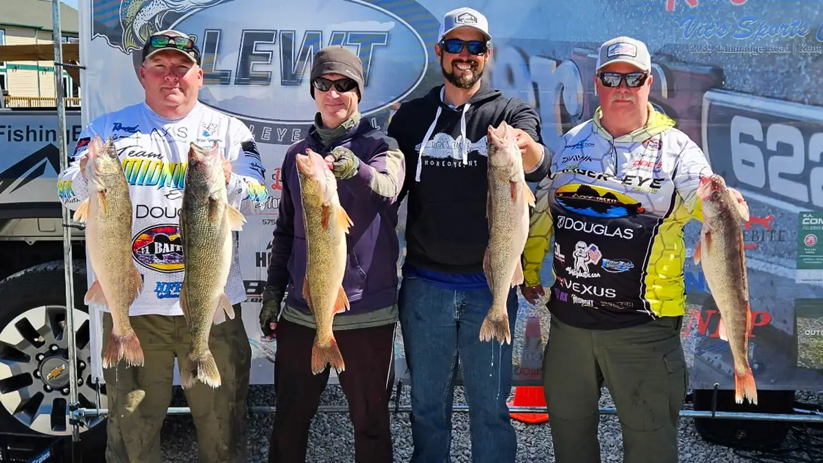 Four anglers show off the five walleye they caught among them.