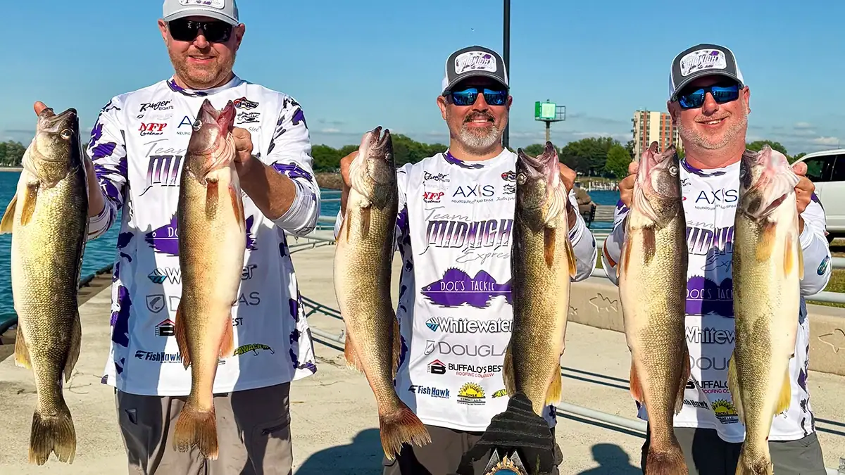 Three anglers show off the six walleye they caught among themselves.